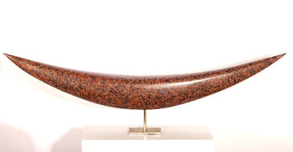 A polished reddish crescent form on a slender metal mount and pale base.