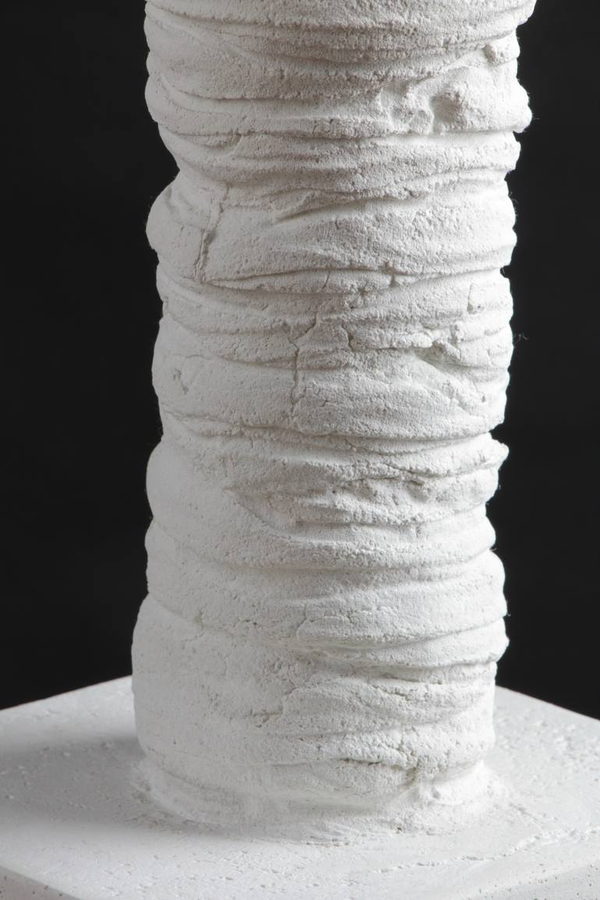 Close detail of the white wrapped surface and its junction with the pale square base.